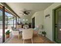 Inviting outdoor patio featuring comfortable wicker seating, a ceiling fan, and a built-in bar area for relaxation at 10277 Rosetti Ct, Spring Hill, FL 34608