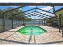 Relaxing screened-in pool area with brick pavers, creating an ideal outdoor entertaining space at 10277 Rosetti Ct, Spring Hill, FL 34608