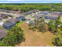 Expansive aerial view of a residential community, lush greenery, and neighborhood streets at 11579 Weaver Hollow Rd, New Port Richey, FL 34654