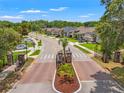 Gated community entrance with manicured landscaping and well-maintained neighborhood street at 11579 Weaver Hollow Rd, New Port Richey, FL 34654