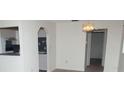 Open-concept dining area showcases a vintage chandelier and transitions to a well-lit kitchen at 11715 Boynton Ln # 74B, New Port Richey, FL 34654