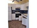Functional kitchen features white cabinets, black appliances, and practical layout at 11715 Boynton Ln # 74B, New Port Richey, FL 34654