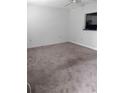Bright living room offers a pass-through window to the kitchen and ample space at 11715 Boynton Ln # 74B, New Port Richey, FL 34654