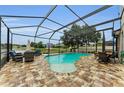 A luxurious in-ground pool with a screened enclosure and plenty of room for outdoor seating and entertaining at 1236 Ketzal Dr, Trinity, FL 34655