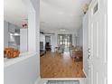 Inviting interior featuring an open-concept living space, hardwood floors, and ample natural light at 13627 Lightning Rod Ct, Hudson, FL 34669