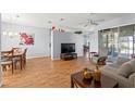 Bright and airy living room featuring hardwood floors and access to the dining and living spaces at 13627 Lightning Rod Ct, Hudson, FL 34669