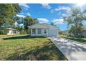 Charming single-Gathering home featuring a covered porch, attached garage, and fresh landscaping at 14376 Earline Rd, Brooksville, FL 34614