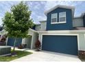 Well-maintained townhome with a blue garage door and a clean, paved driveway at 1508 Figleaf Ln, Clearwater, FL 33756