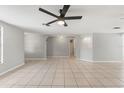 Spacious living room with tile floors and modern ceiling fan at 16018 Adobe Dr, Hudson, FL 34667