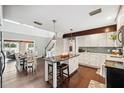 Modern kitchen featuring an island with bar stool seating, granite countertops, and sleek, updated appliances at 1602 Beachway Ln, Odessa, FL 33556