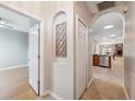 Inviting hallway featuring arched doorways and tile flooring with a glimpse into the dining area at 1623 Crossvine Ct, New Port Richey, FL 34655