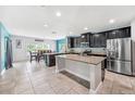 Open kitchen with granite countertops, stainless steel appliances, and large island at 18566 Hunters Meadow Walk, Land O Lakes, FL 34638