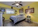A cozy bedroom featuring neutral flooring, yellow walls, and decoratively-framed wall art for an inviting space at 1934 Golfview Dr # 1934, Tarpon Springs, FL 34689