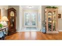 Elegant foyer featuring beautiful double doors and wood floors at 2310 Augusta Dr, Spring Hill, FL 34606