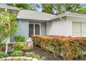 Inviting front entrance with beautiful landscaping and double doors at 2310 Augusta Dr, Spring Hill, FL 34606