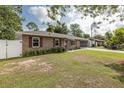 Charming single-story brick home with well-maintained lawn and screened in garage at 27263 Warner Ave, Brooksville, FL 34602