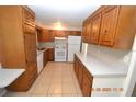 Spacious kitchen with wood cabinets, white appliances, and tile flooring at 300 Midwood Dr, Plant City, FL 33566
