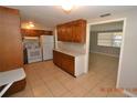 Traditional kitchen with wood cabinets, white appliances, and tile flooring at 300 Midwood Dr, Plant City, FL 33566