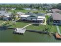 Charming waterfront home with a well-manicured lawn, private dock, and serene water views at 3140 Jackson Dr, Holiday, FL 34691