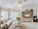 Bright living room featuring vaulted ceilings, fan, elegant furniture, and large windows at 3832 Sailmaker Ln # 3832, Holiday, FL 34691