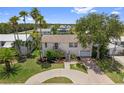 Attractive two-story home surrounded by lush landscaping and mature palm trees at 4048 Bluefish Dr, Hernando Beach, FL 34607