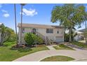 Inviting home with a well-manicured lawn, front garden, and a welcoming stairway entrance at 4048 Bluefish Dr, Hernando Beach, FL 34607