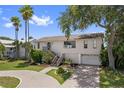 Inviting two-story home featuring well-maintained landscaping and a charming stairway entrance at 4048 Bluefish Dr, Hernando Beach, FL 34607