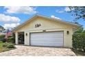Close-up of a one-story home with a brick driveway, a two car garage and a covered front entry at 4072 Everett Ave, Spring Hill, FL 34609