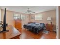 Cozy bedroom with hardwood floors, ceiling fan, and lots of natural light at 4350 Sawgrass Blvd, New Port Richey, FL 34653