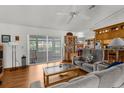 Inviting living room with wood floors and sliding doors to an enclosed patio at 5035 Harbinger Rd, Spring Hill, FL 34608