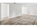A bright, freshly painted living room featuring modern wood flooring and neutral color palette at 5323 23Rd St, Zephyrhills, FL 33542