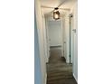 Hallway view featuring wood-look flooring and contemporary lighting at 6108 Maplewood Dr, New Port Richey, FL 34653