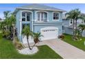 Charming two-story home featuring a front-facing two-car garage and a small balcony at 6140 Seaside Dr, New Port Richey, FL 34652