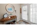 Welcoming entryway features a decorative mirror, coastal decor, and a charming accent table at 639 Garland Cir, Indian Rocks Beach, FL 33785