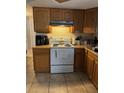 Functional kitchen featuring wood cabinets and a white range at 7222 Coventry Dr, Port Richey, FL 34668