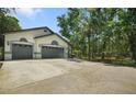 Spacious home featuring a two-car garage, well-maintained landscaping, and ample parking space at 8518 Quail Hollow Blvd, Wesley Chapel, FL 33544