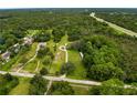 Aerial view of a home and its expansive, tree-filled property next to a highway at 8540 Roseanne Blvd, New Port Richey, FL 34654