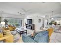 Bright living room featuring comfortable seating, a modern fireplace, and sliding glass doors to the outdoors at 10093 Holly Berry Dr, Weeki Wachee, FL 34613