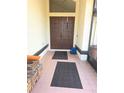 A close up of the entryway showing a double door design, tile flooring, and covered space at 10244 Hoover St, Spring Hill, FL 34608