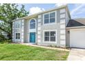 Two-story home with attractive architectural detailing and a well maintained green lawn at 10386 Norvell Rd, Spring Hill, FL 34608