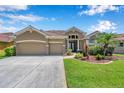 Charming home with a two-car garage, beautiful landscaping, and inviting entrance at 11726 Belle Haven Dr, New Port Richey, FL 34654