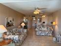 Cozy living room with floral sofas, tile floors, and a view into the dining area at 1243 S Martin Luther King Jr Ave # C505, Clearwater, FL 33756