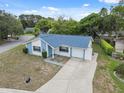Aerial view of a cozy single-story home with a long driveway and well maintained lawn at 13001 Sawmill Way, Hudson, FL 34667
