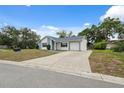 Charming single-story home featuring a private driveway, lush lawn, and traditional mailbox at 13001 Sawmill Way, Hudson, FL 34667