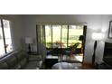 Relaxing living room area with sliding glass door to the lanai at 13010 Wedgewood Way # A, Hudson, FL 34667