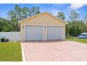 A detached two-car garage with painted driveway and manicured grass at 13444 English Parrot Rd, Brooksville, FL 34614