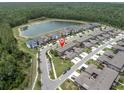 Aerial view of community homes near lake; the listing has a red pin for location at 17316 Cruiser Bnd, Land O Lakes, FL 34638
