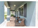Cozy front porch with wicker furniture; a relaxing outdoor space at 17316 Cruiser Bnd, Land O Lakes, FL 34638
