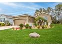 Charming home with lush landscaping, green grass, and beautiful exterior at 17679 Garsalaso Cir, Brooksville, FL 34604