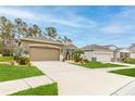 Beautifully landscaped house with a two-car garage and inviting curb appeal at 17679 Garsalaso Cir, Brooksville, FL 34604